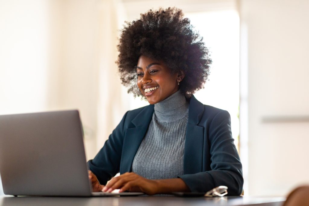 Black businesswoman working on laptop in office